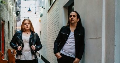 The Rising Band standing against a wall in a dramatic pose