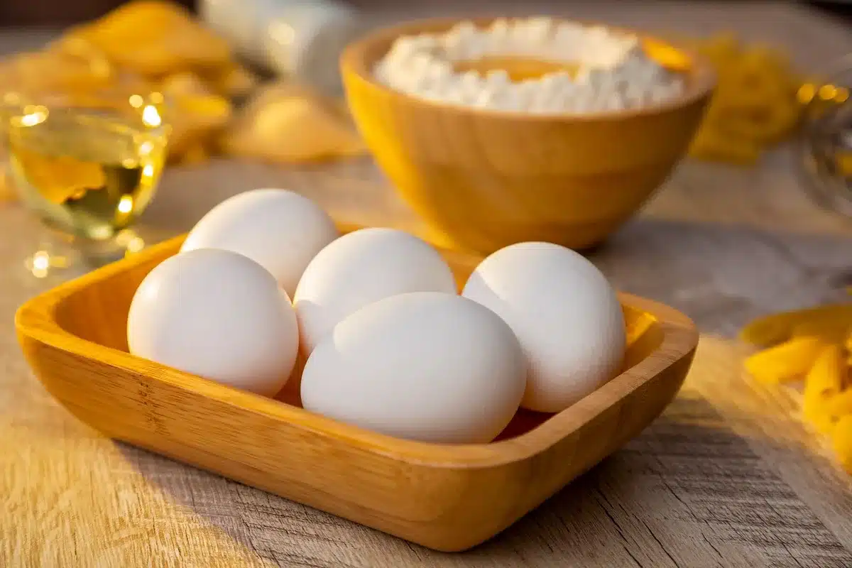 Variety of eggs and kitchen ingredients arranged on a countertop