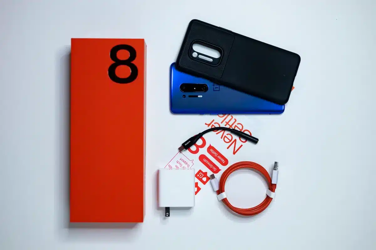 Complete smartphone package with original box, charger, and accessories displayed together