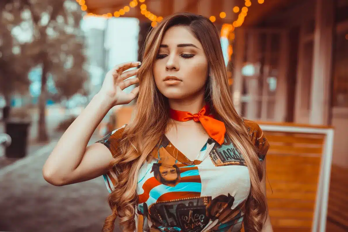 Woman with bold ribbon highlights in her hair, showing defined color streaks and dimension