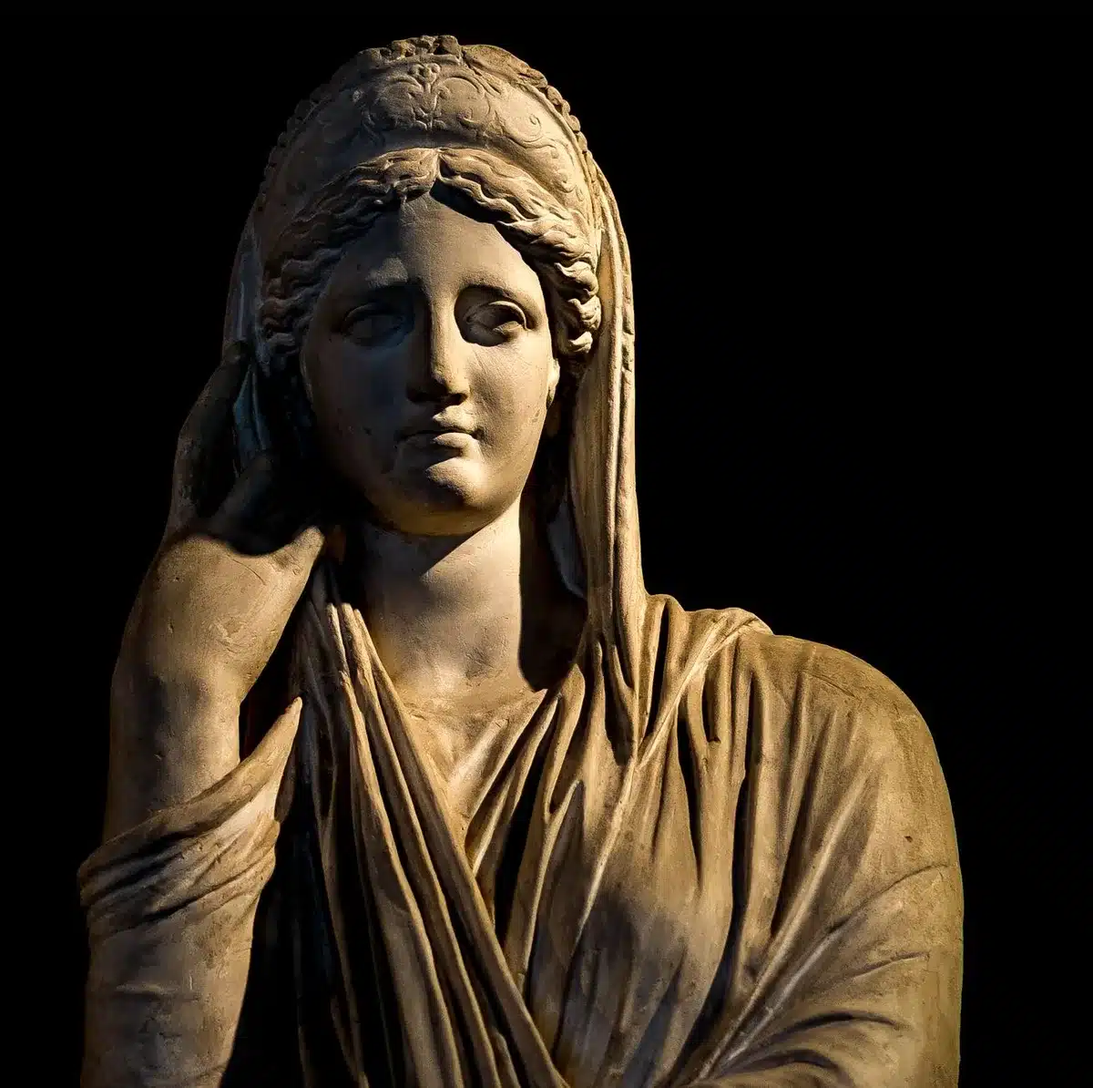 Statues and artistic representations of Greek goddesses symbolizing wisdom and mythology