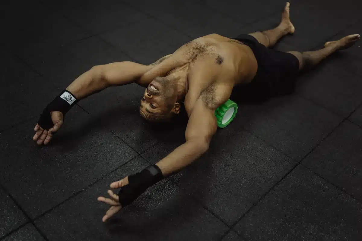 A textured foam roller being used on legs and muscles for recovery