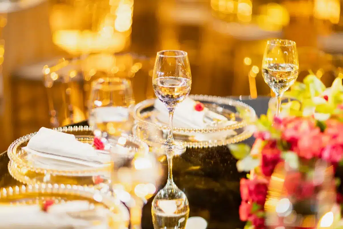 Elegant ballroom with grand chandeliers and guests in formal attire at an upscale dinner event