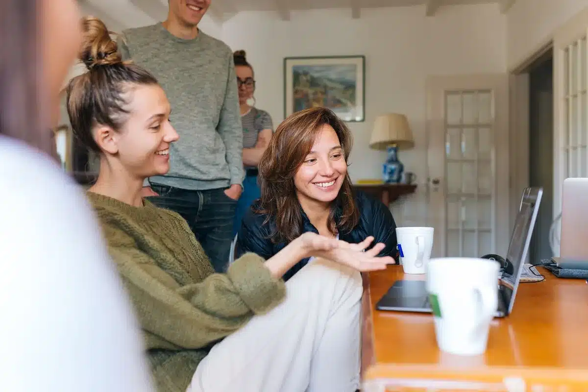 Group of friends in their twenties having a serious conversation in a shared apartment living room