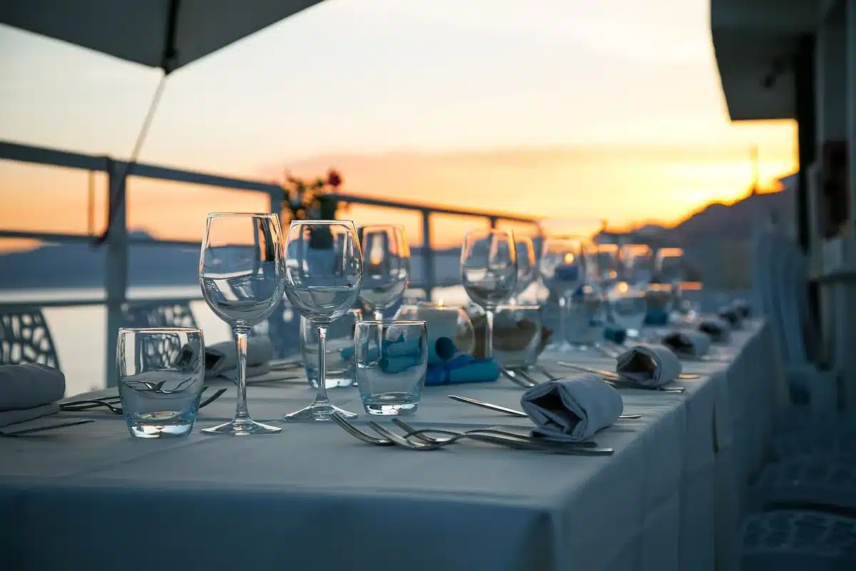 Elegantly set dinner table with candles and wine glasses at a formal event