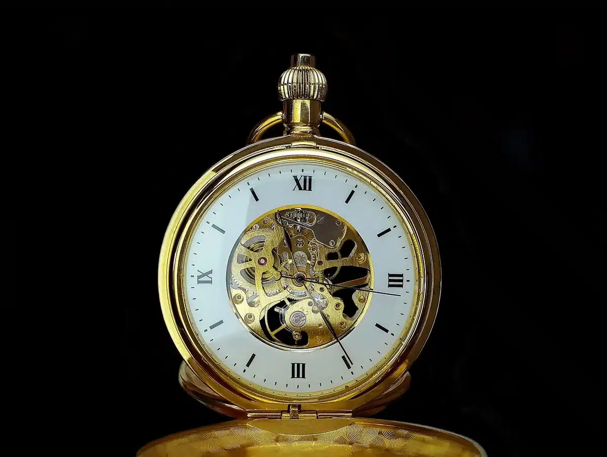 Close-up of a gold medallion with engraving and delicate rubies