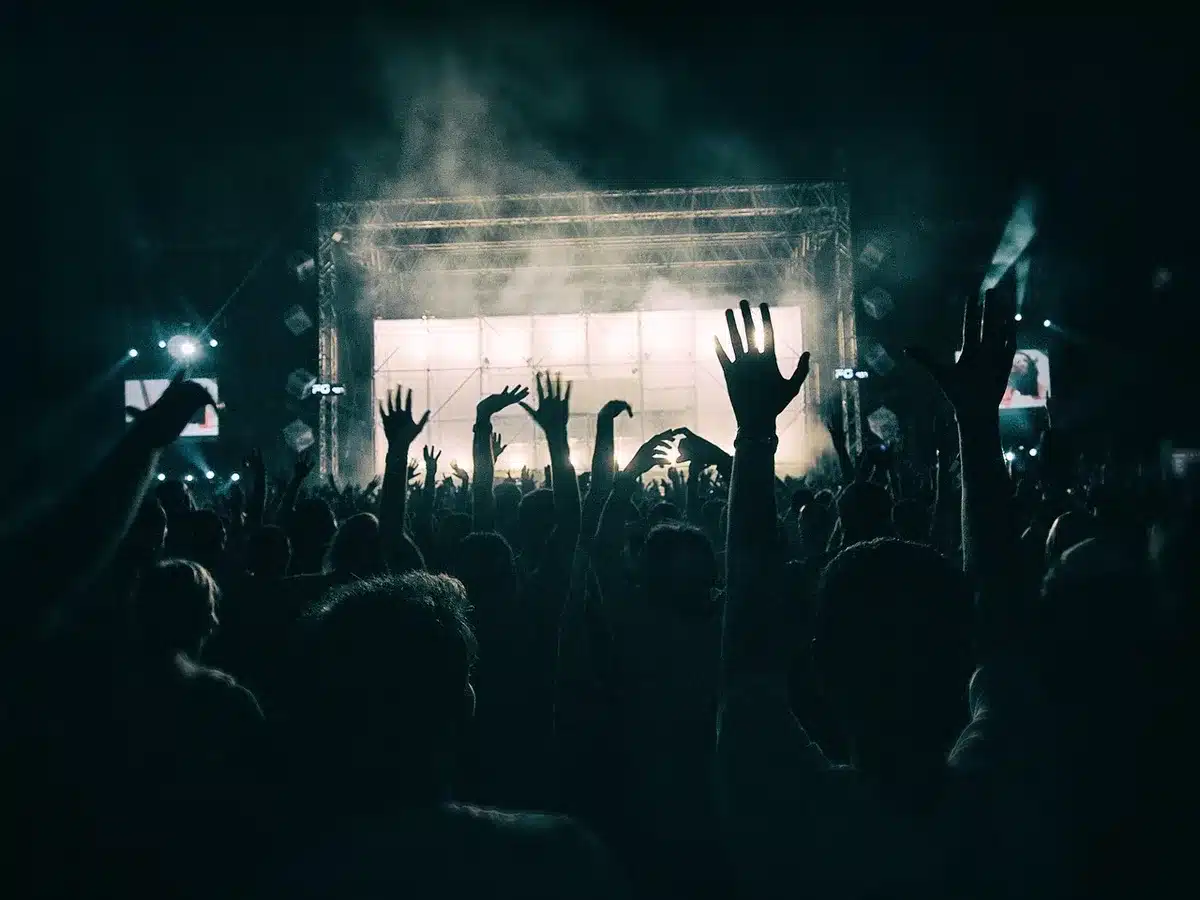 A dance competition stage set with dramatic lighting and professional dancers in performance attire.