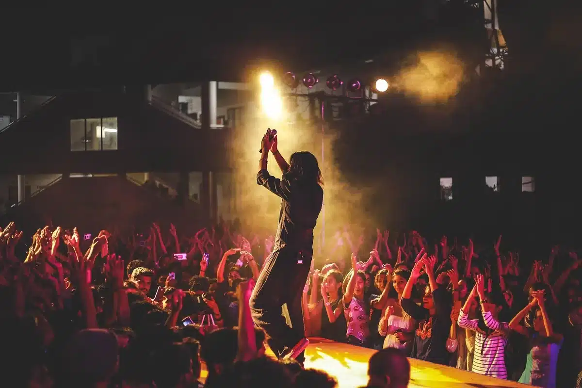 Rock band performing on stage with energetic crowd