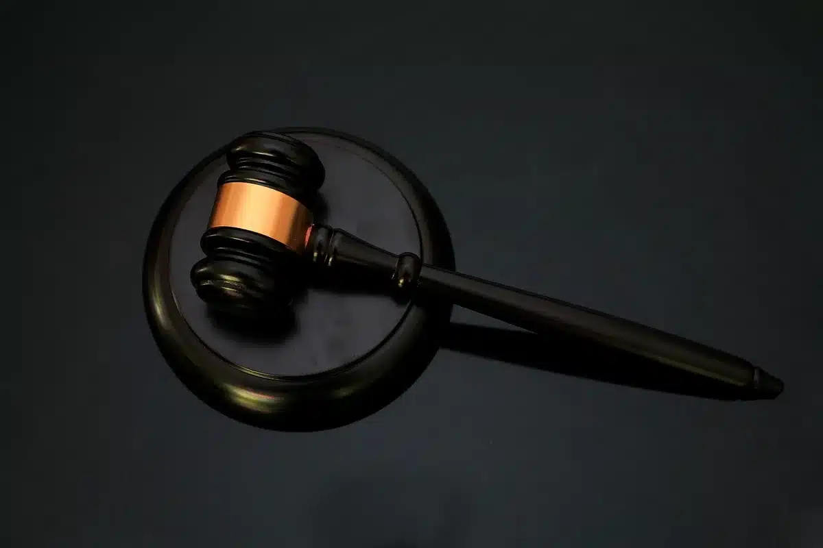 Legal complaint and gavel on a courthouse desk