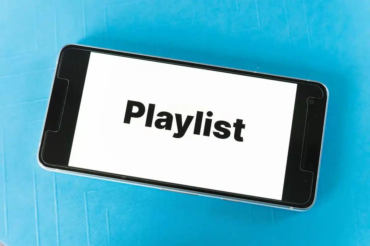 Person holding tablet showing streaming app menu with AMC+ listed