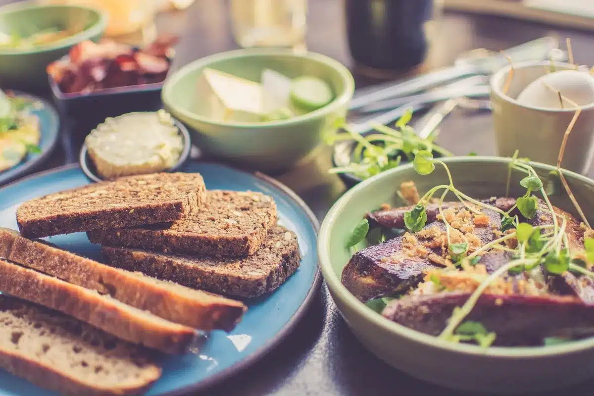 Sandwich bread toasting in a skillet with olive oil
